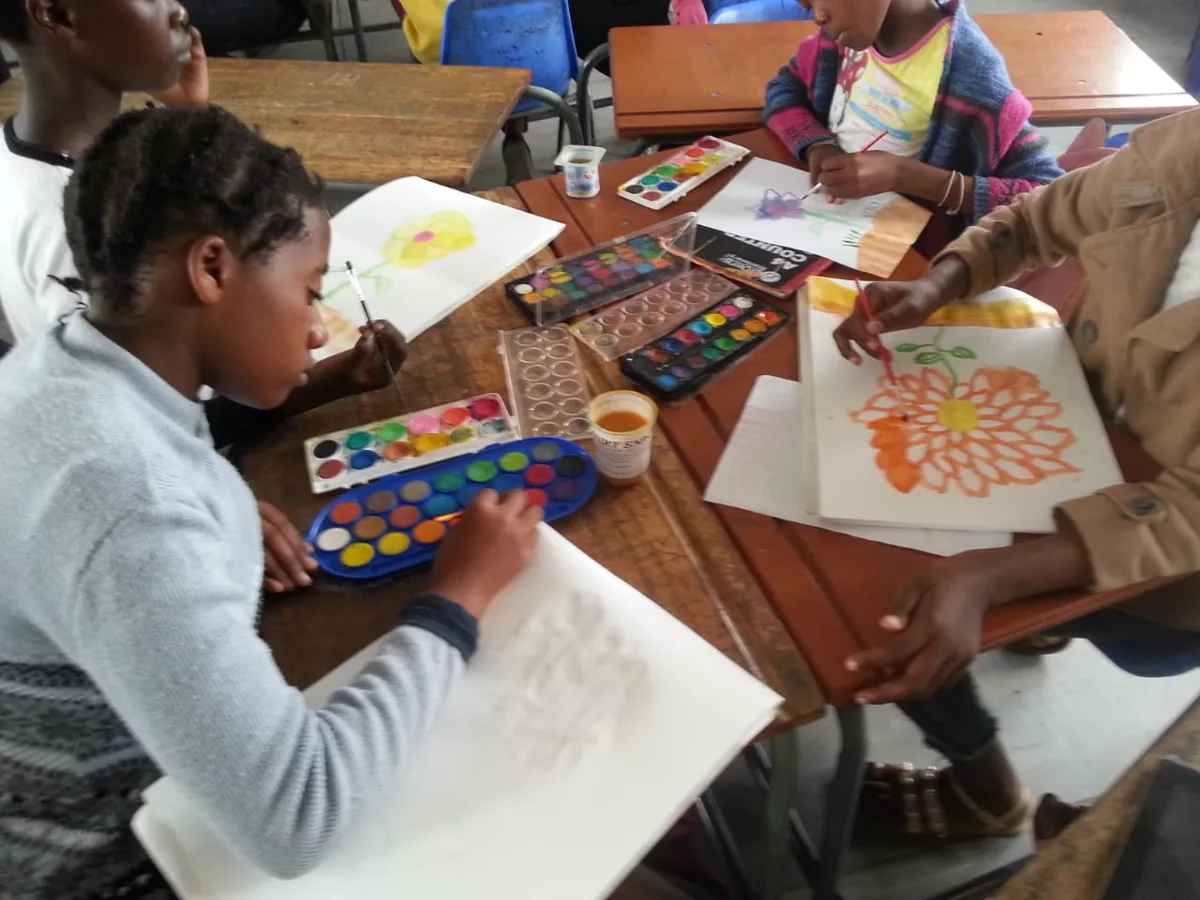 Children painting with watercolours at a heART workshop