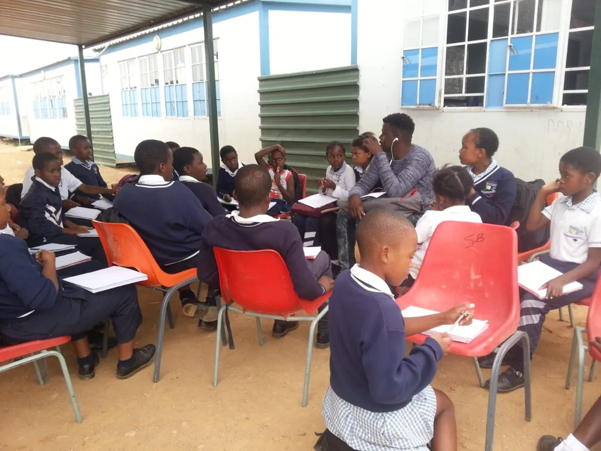 Learners with their sketchbooks at an outdoor class