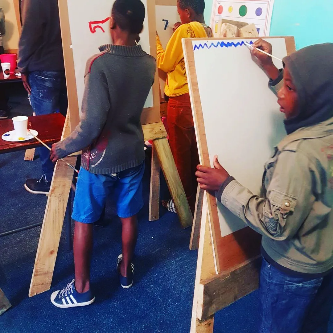 Learners painting at easels