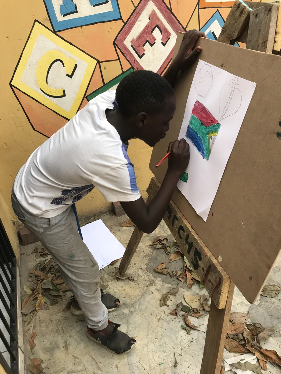 A learner painting the South African flag