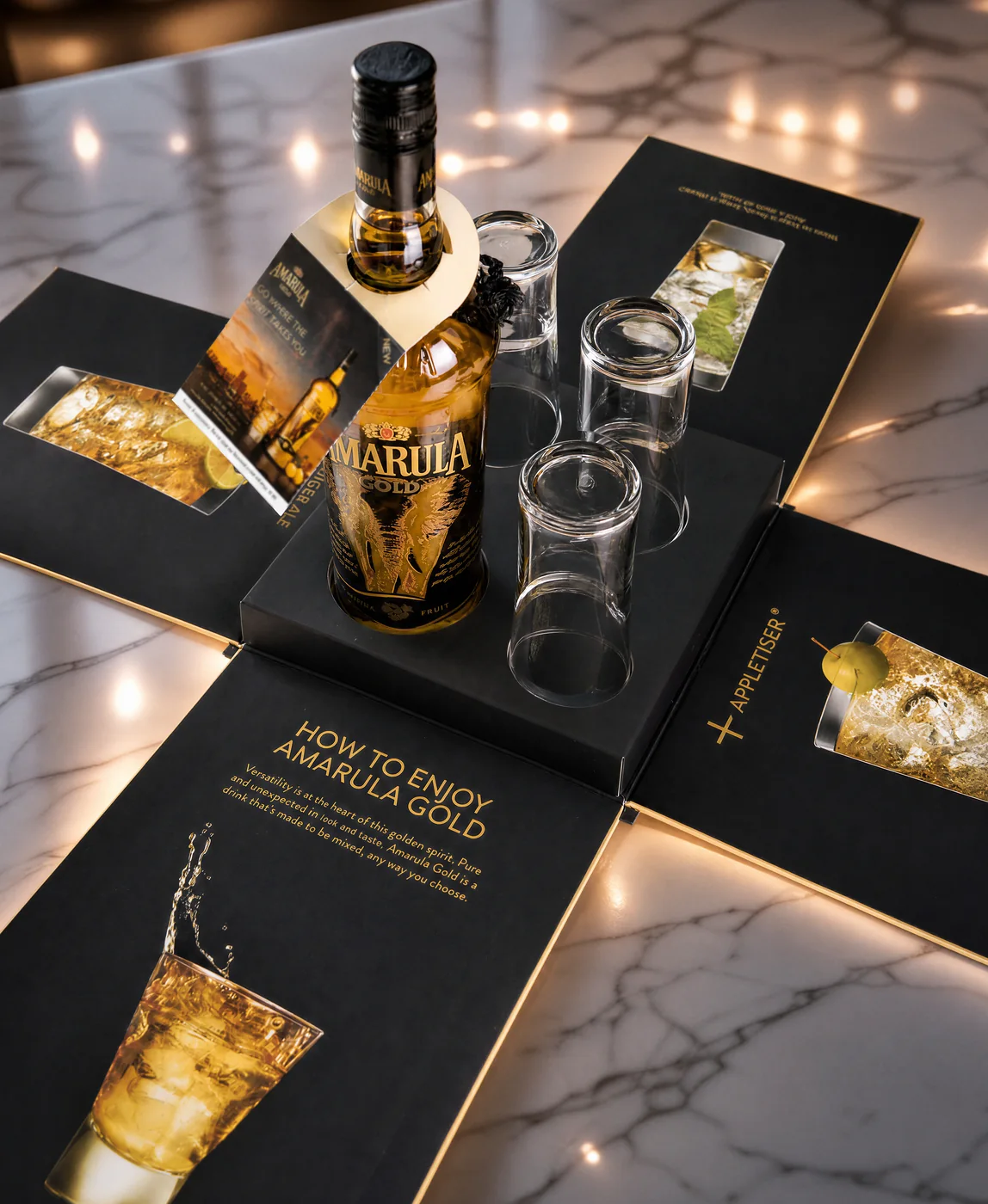 Amarula Gold presentation pack opened flat, with bottle, glasses and serving guide