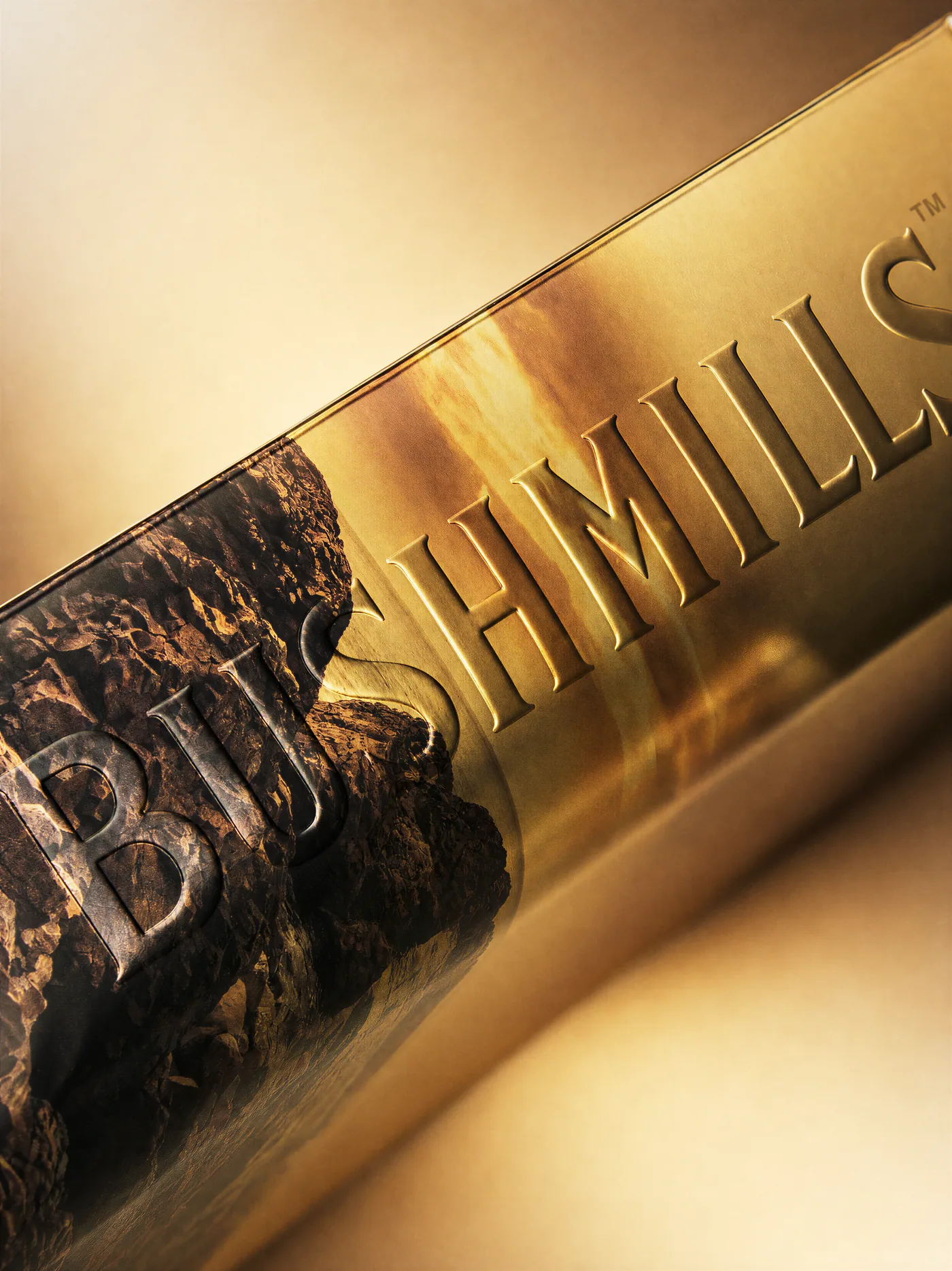Embossed Bushmills lettering on metallic board, close up