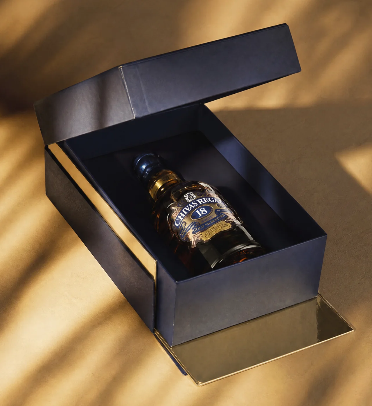 The box opened, bottle seated in its fitted tray