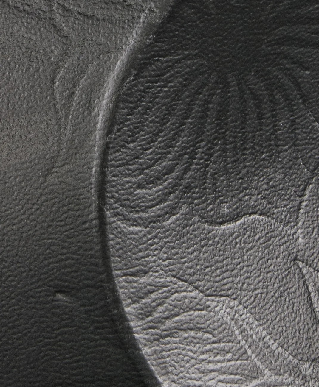 Embossed floral texture on the Scintilla tube, close up