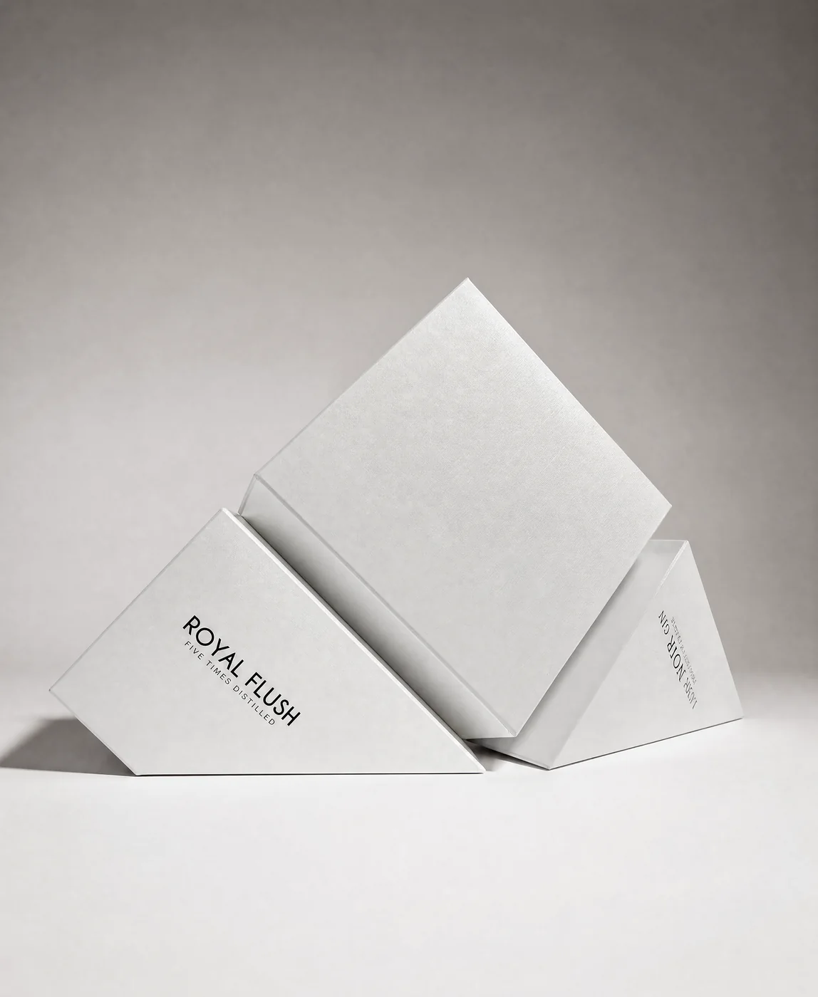 Royal Flush gin cartons in white board, angled on their points