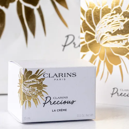 Clarins Precious La Crème carton with a gold foil flower